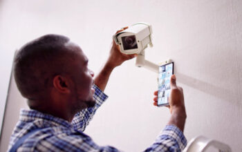 205440011-african-american-using-security-and-alarm-system-on-mobile-phone